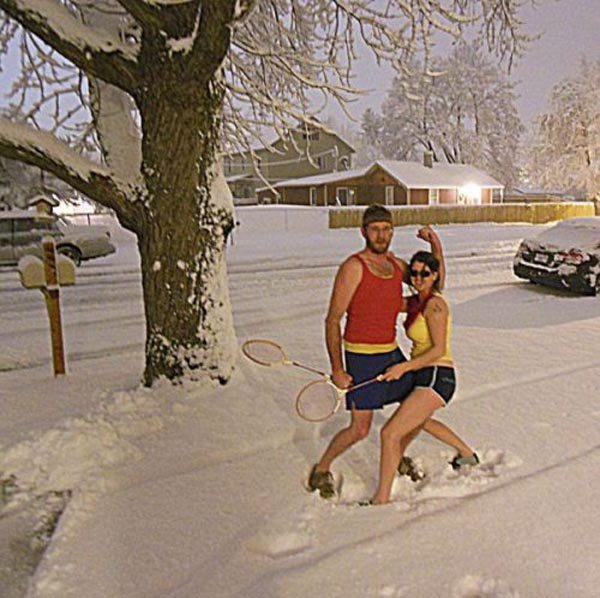 funny-couple-playing-tennis-in-snowfall
