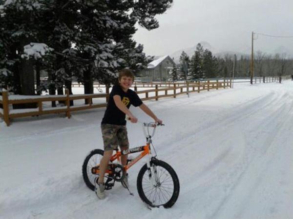 young-guy-cucling-in-snow-fall